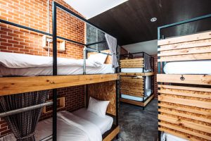 Hostel room with several bunk beds. 