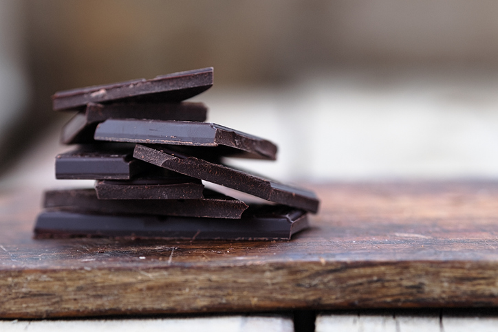 A stack of broken dark chocolate pieces. 