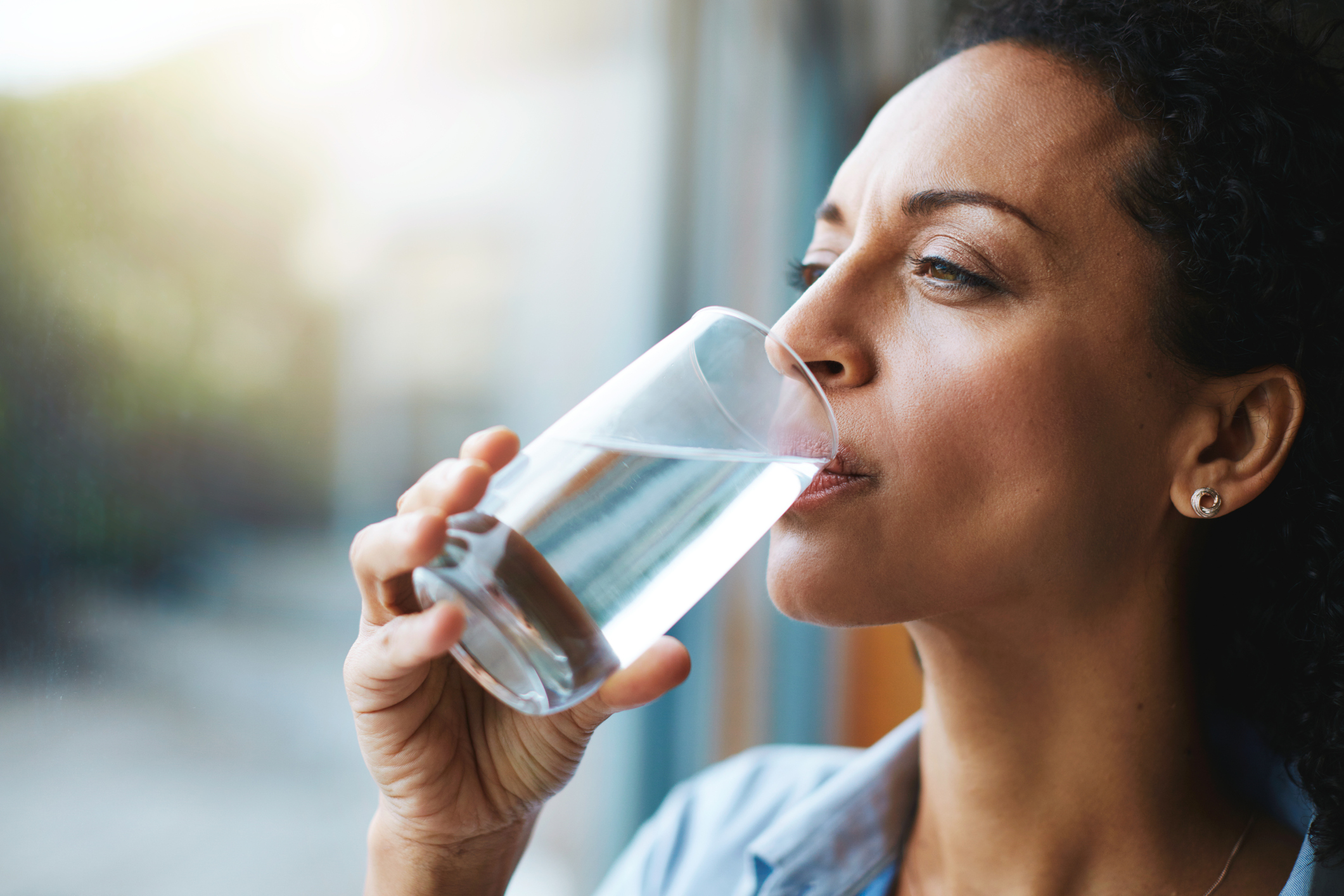 Woman drinking a glass of water. 