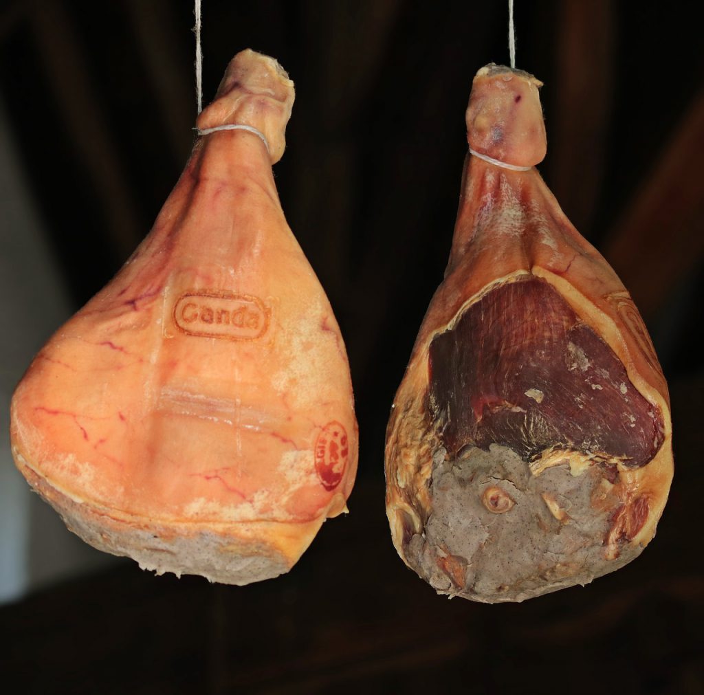 Findyello article on Caribbean Christmas recipes with image of hanging salt-cured ham.