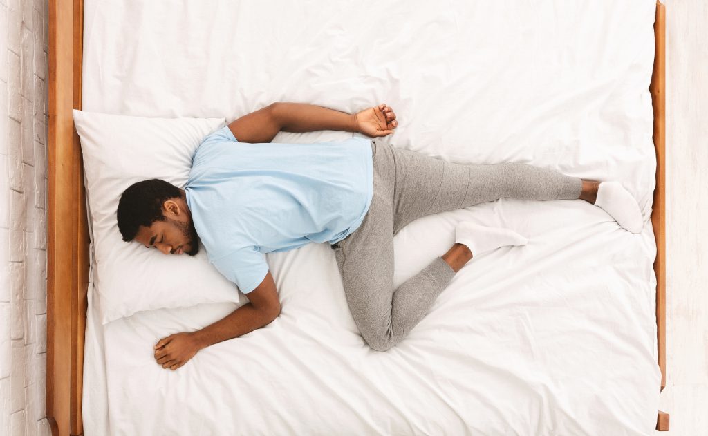 Findyello article four practical tips to detox the mind and body with image  black man sleeping on bed.