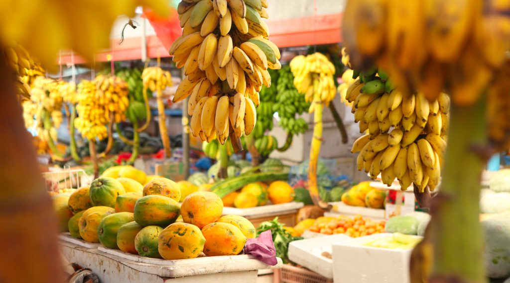FindYello article on Caribbean fruits from July to December image shows bananas and papaya