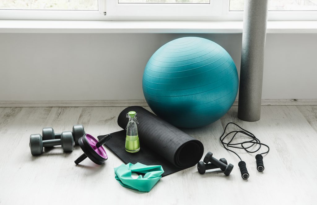 Findyello article six tips to get excited and stay motivated to exercise with photo of various exercise equipment.