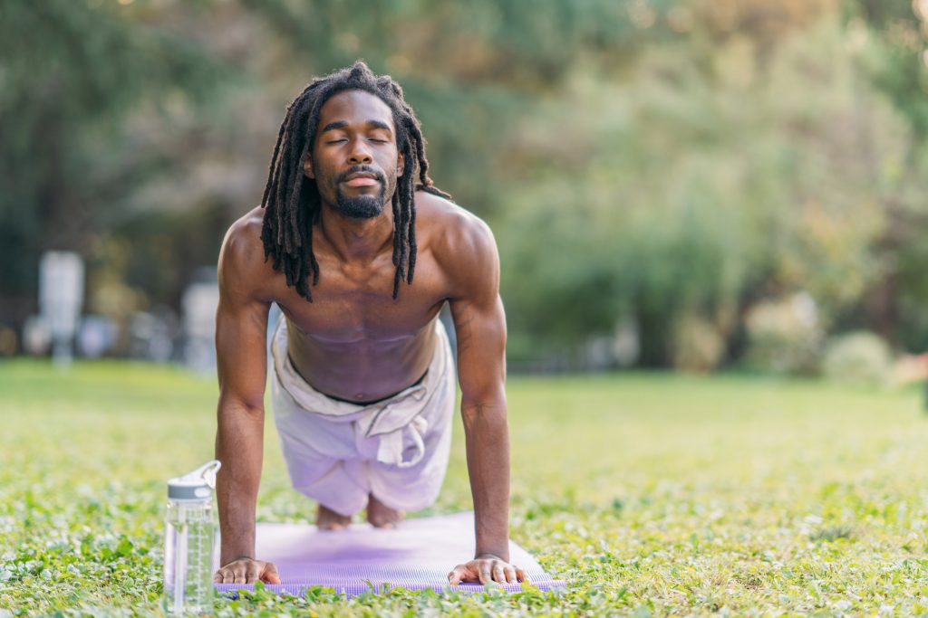 Findyello article on tips to detox the mind and body image shows guy stretching in park.