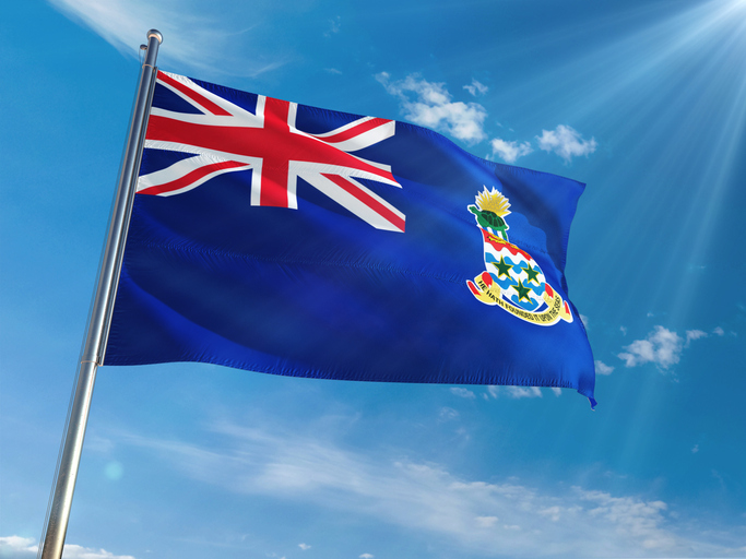 Cayman Islands National Flag Waving on pole against sunny blue sky background. High Definition