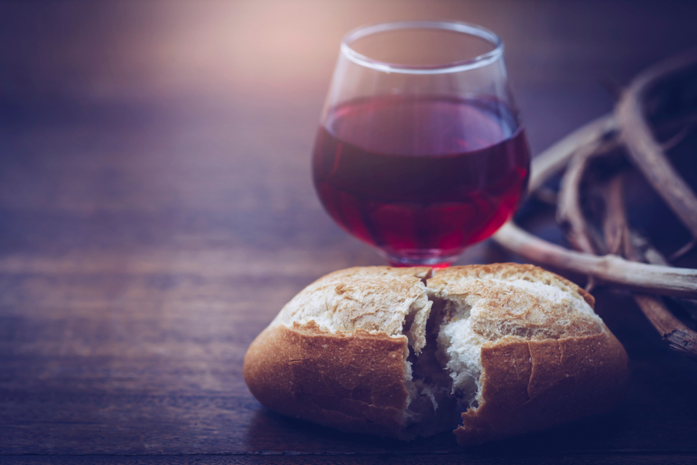 Findyello article on Caribbean Easter traditions with image of glass of wine, bread and crown of thorns