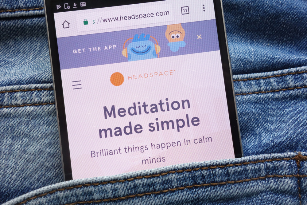 Findyello article 10 lifestyle apps to help you achieve your goals shows image of phone displaying the headspace app in a back pocket.