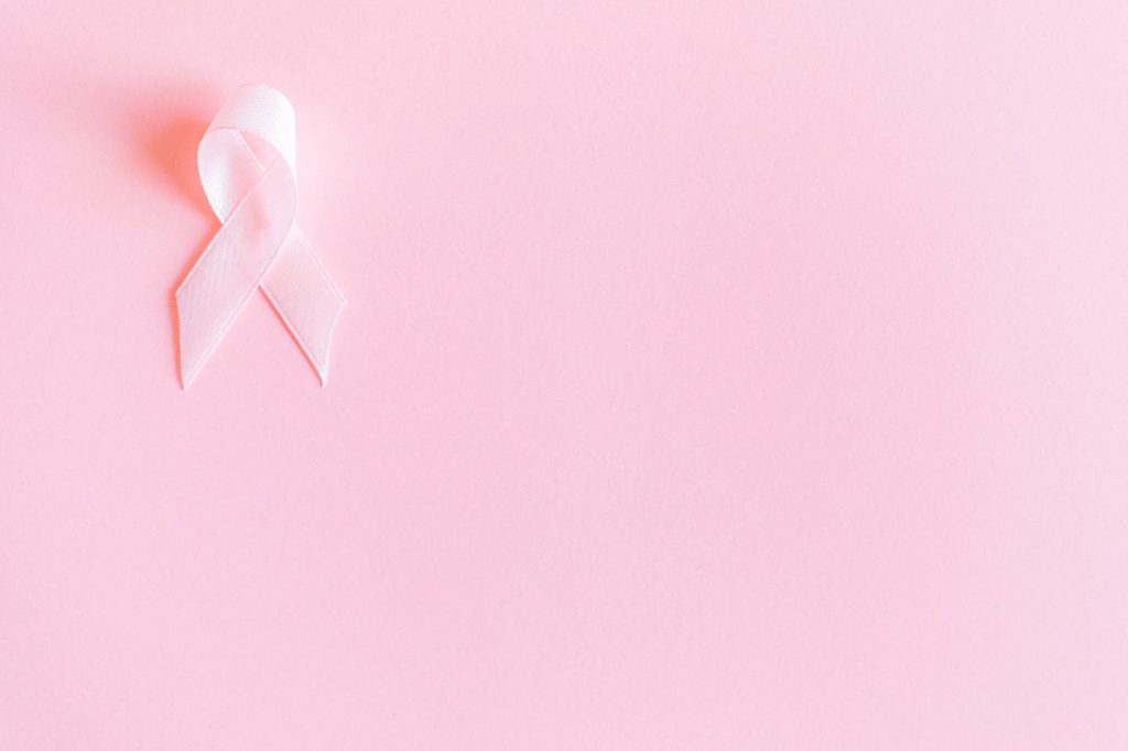 Breast Cancer Awareness pink ribbon against a pink background 