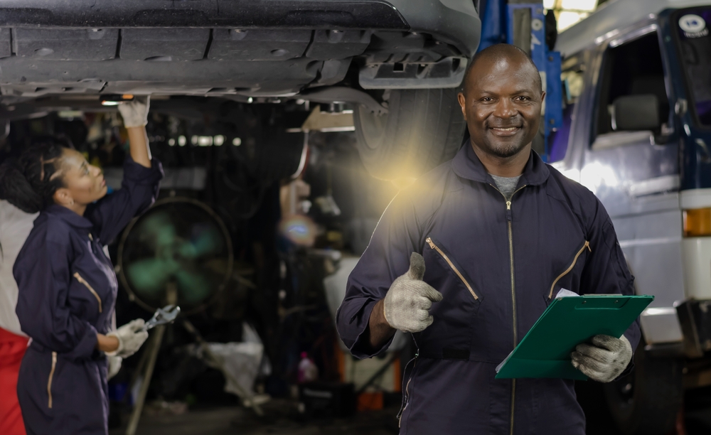Findyello article with top auto care services in Grenada with image of mechanic smiling.